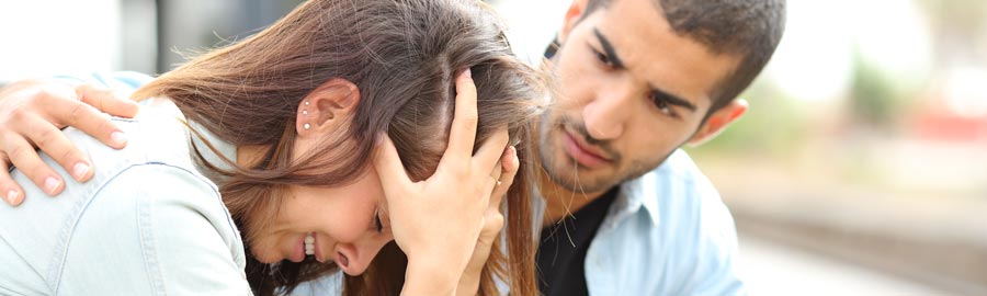 man comforts his girlfriend who relapsed