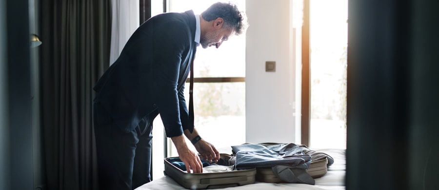 man packing his suitcase after rehab