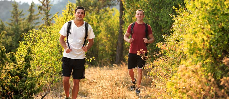 men running in woods