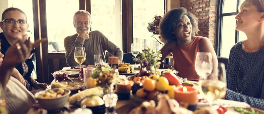 relatives and friends at thanksgiving table