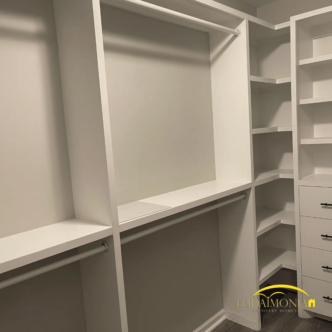 Built-in closet system with white shelving and drawer stacks.