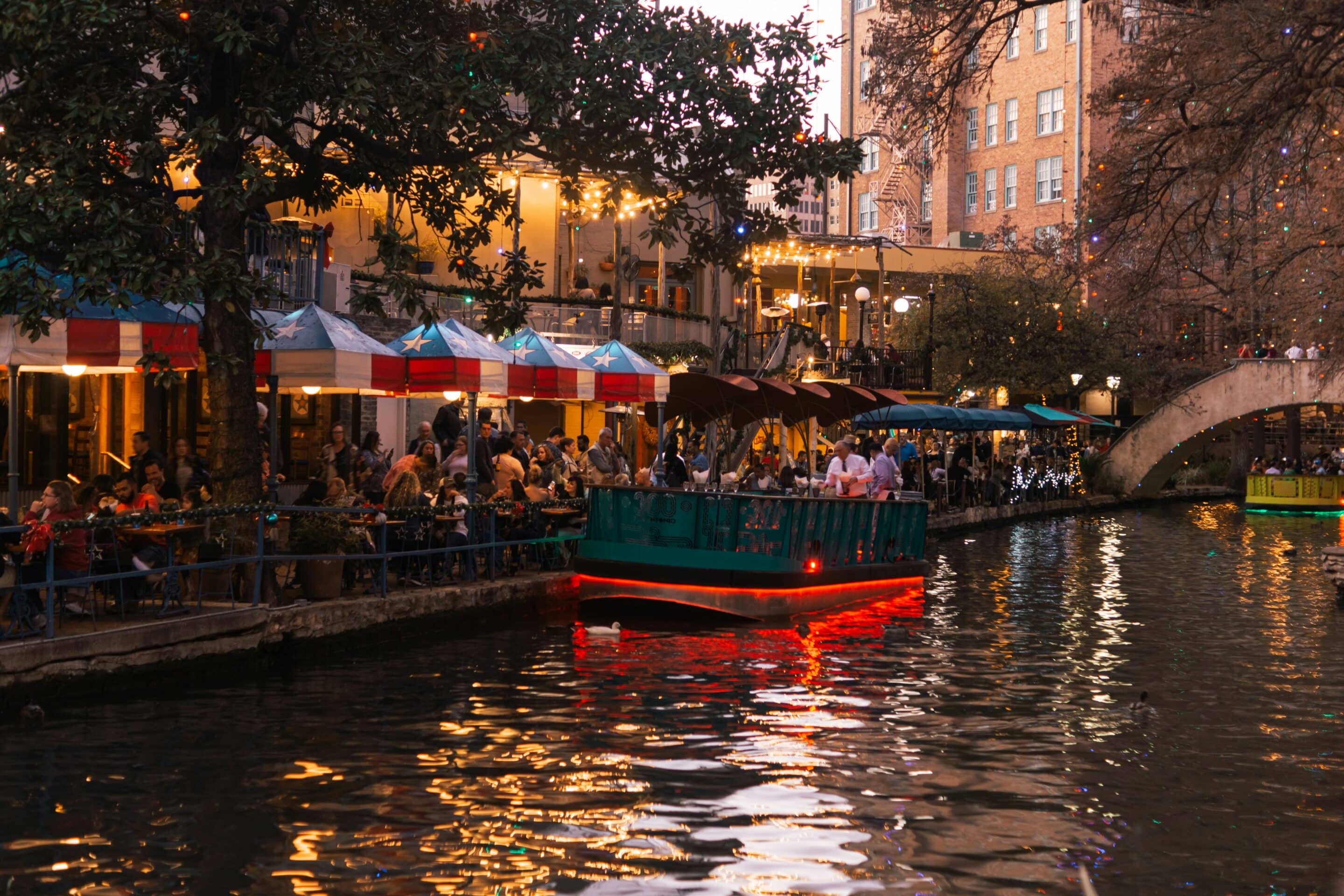 San Antonio River Walk at night with boats and restaurants, representing sober living options in San Antonio, TX