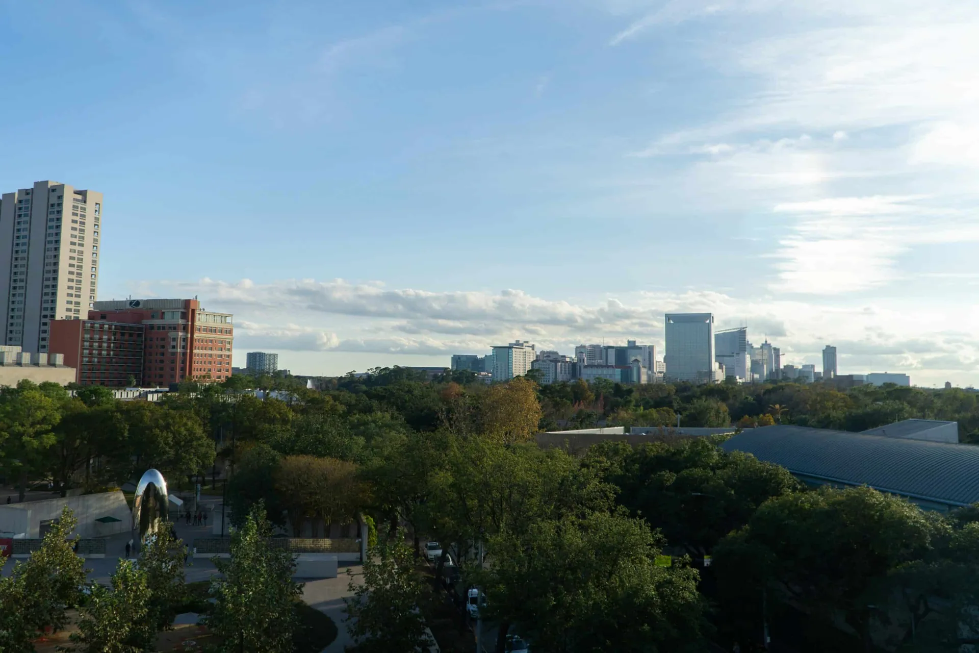 City skyline with greenery representing accessible therapeutic services in outpatient rehab.