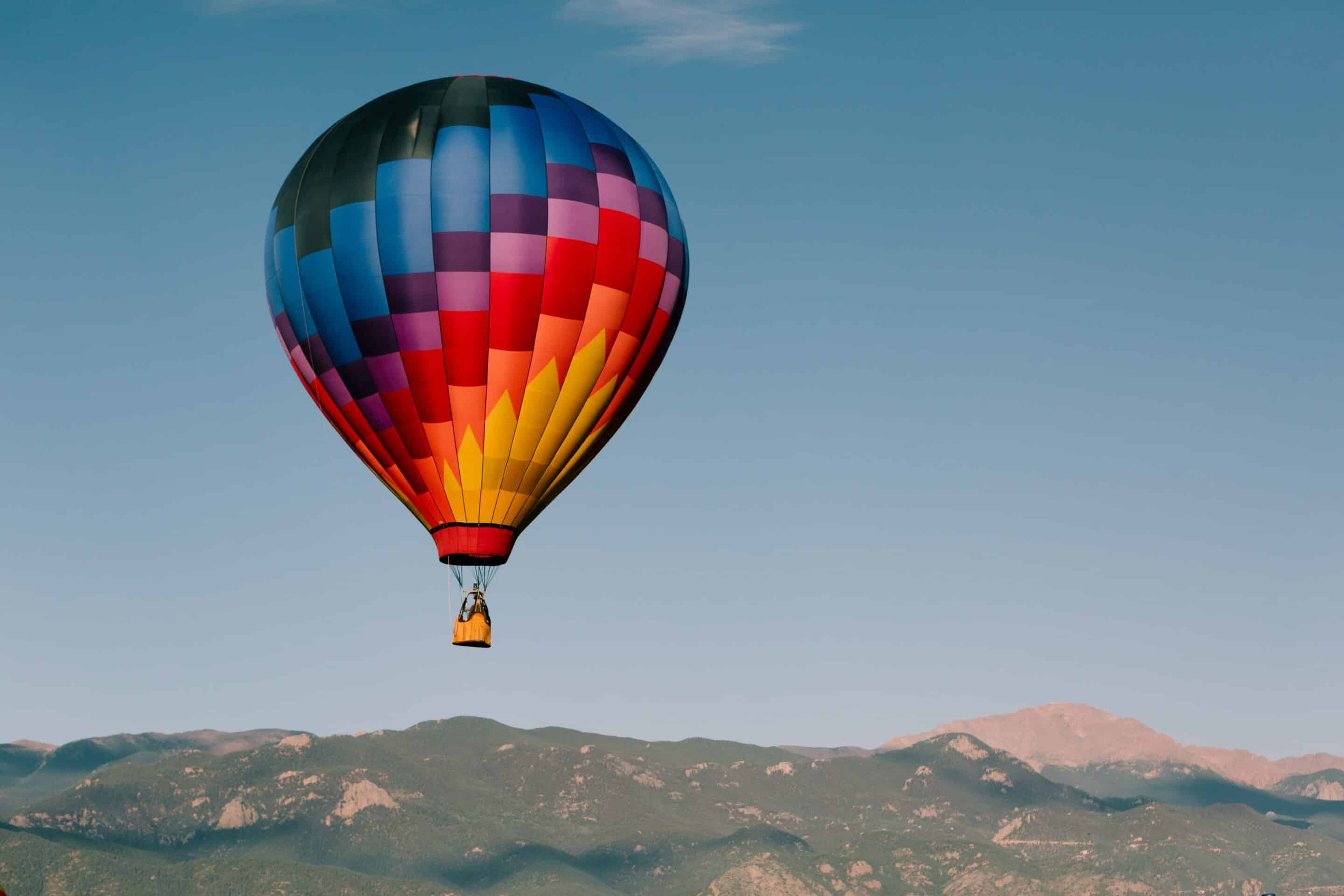 Hot air balloon floating above mountains symbolizing freedom in outpatient recovery.