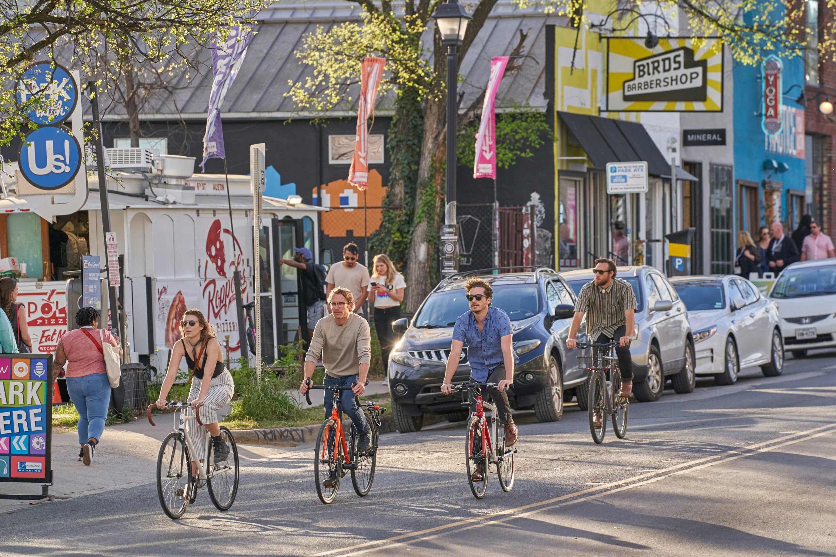 People biking through a city neighborhood symbolizing active lifestyles supported by outpatient recovery.