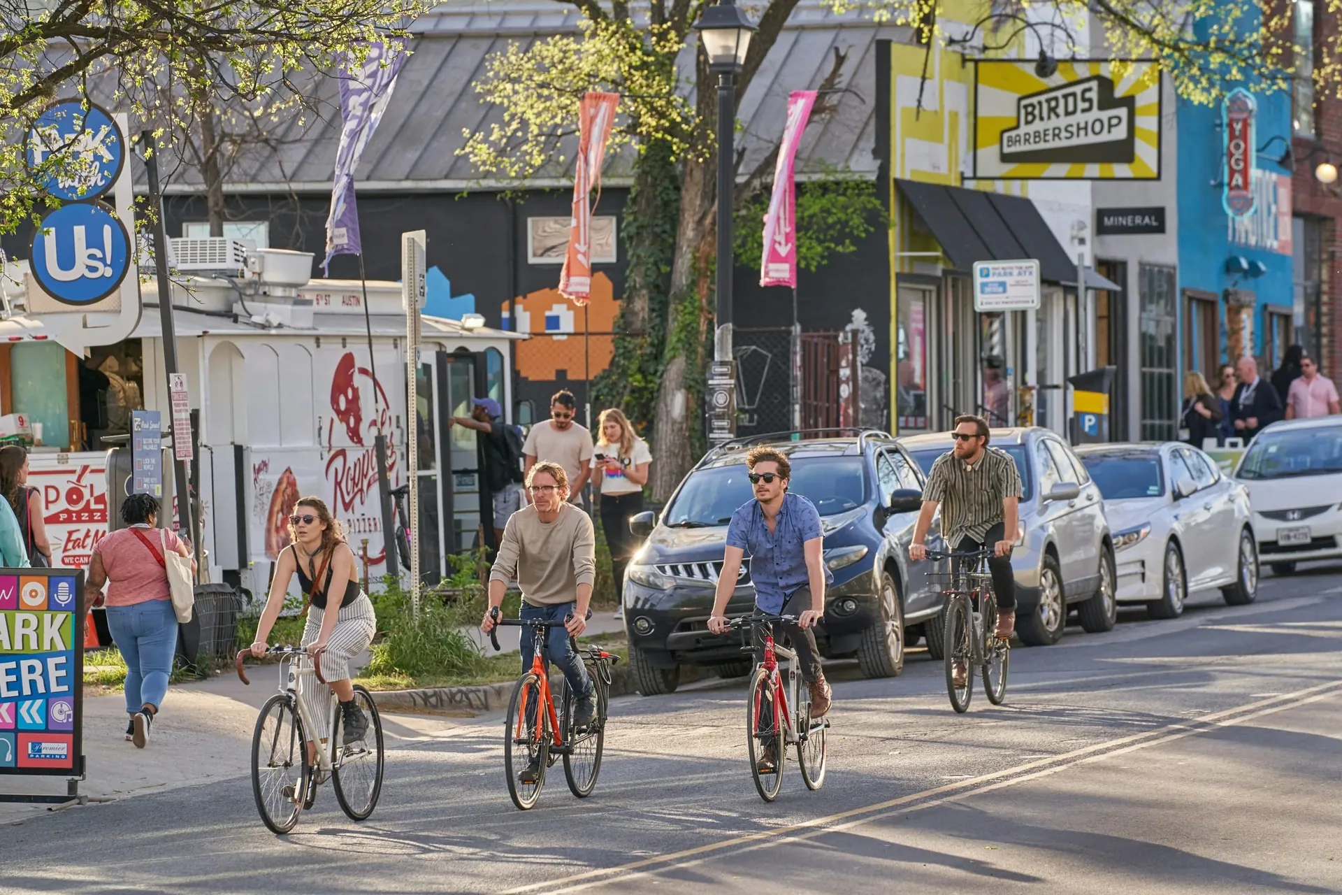 People biking through a city neighborhood symbolizing active lifestyles supported by outpatient recovery.