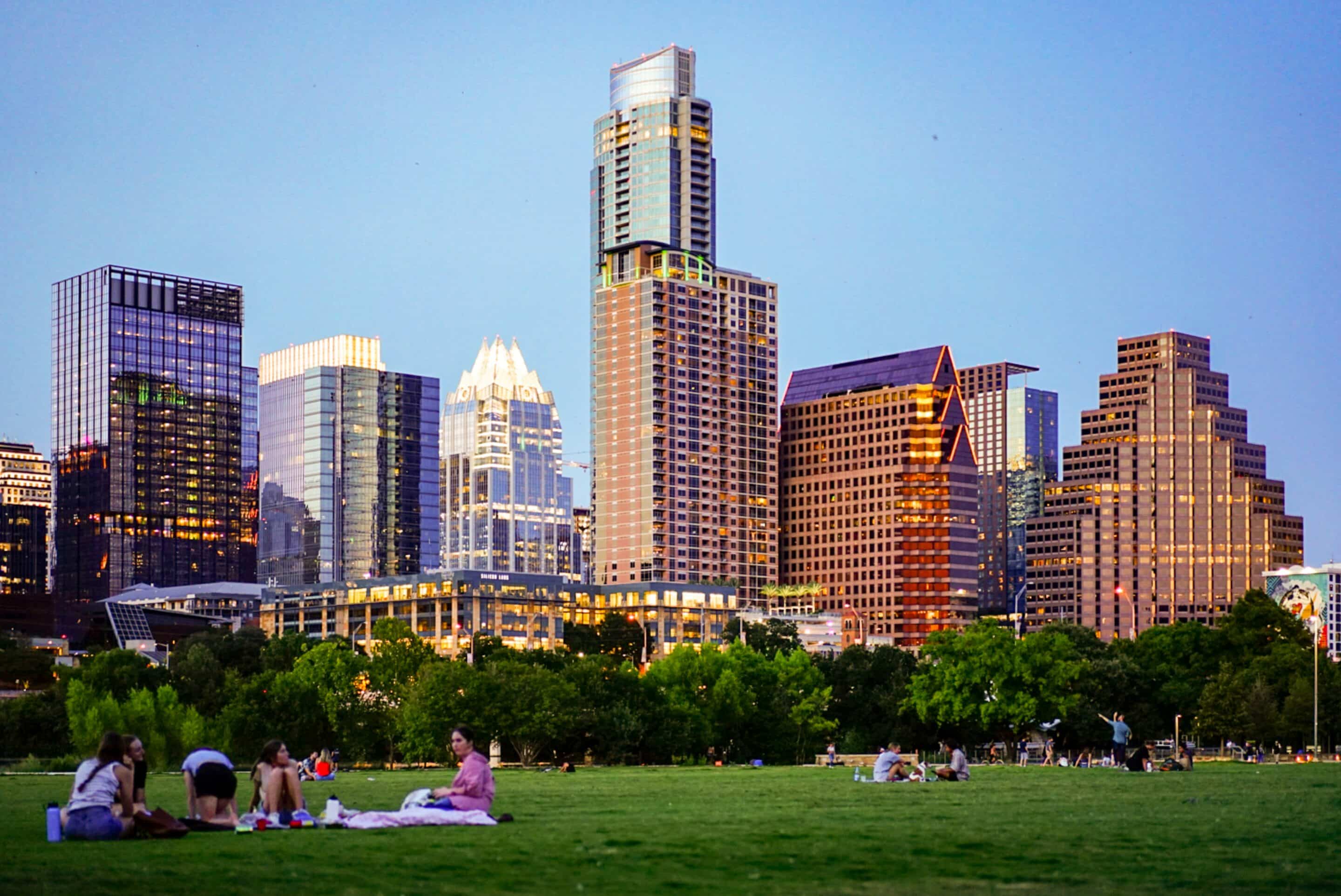 Austin skyline with people in a park representing balance in outpatient rehab.