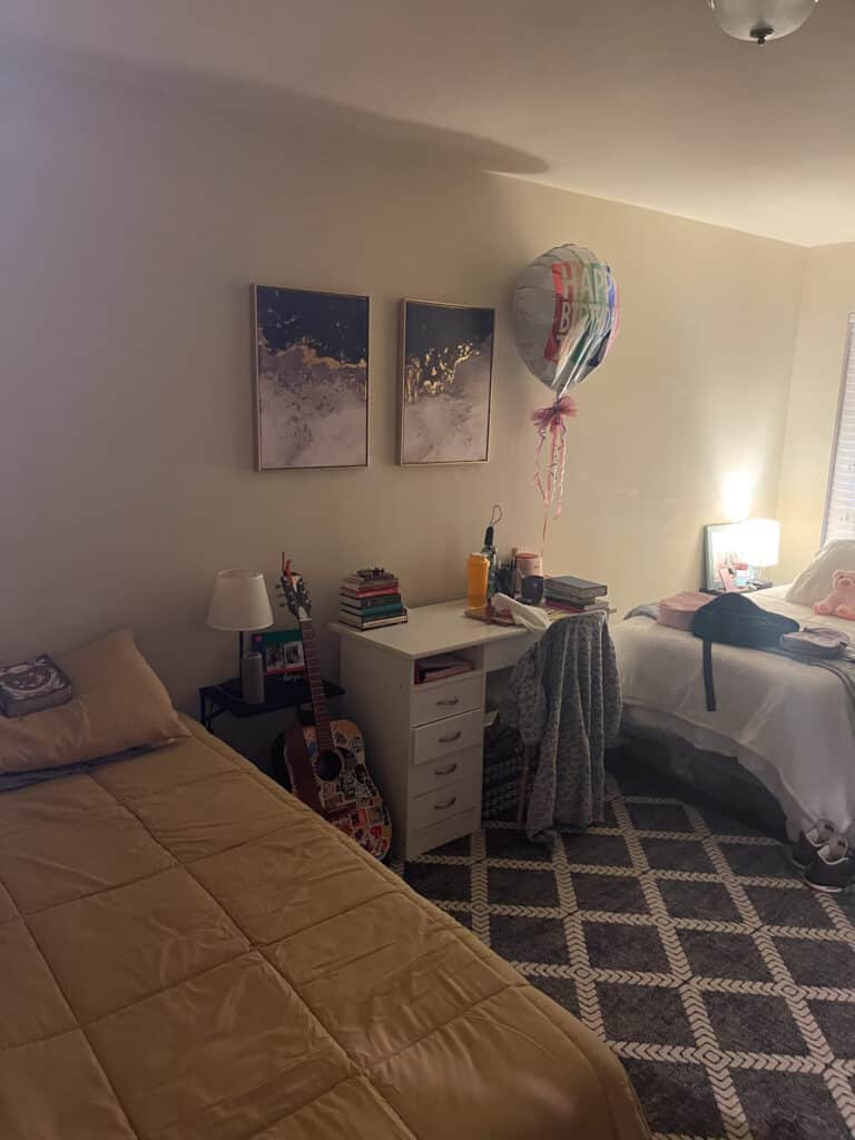 Shared bedroom in Austin sober living home with two beds, desk workspace, and cozy decor
