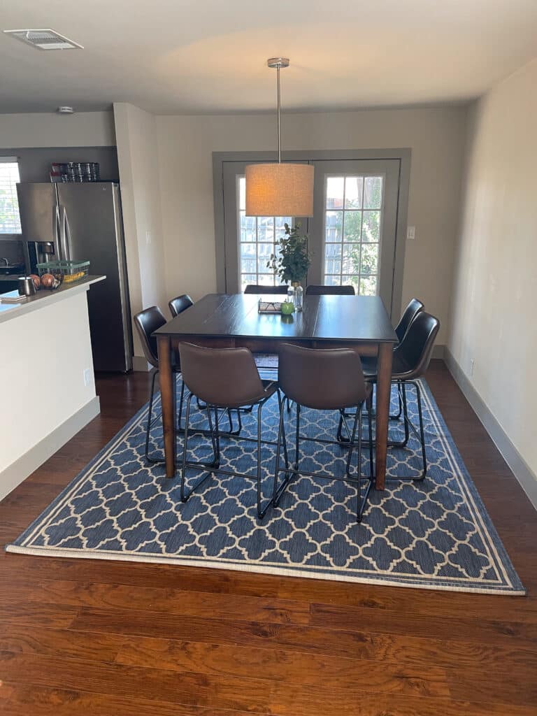 Dining area at Quail Meadow women’s sober living Austin TX with large table and modern kitchen.