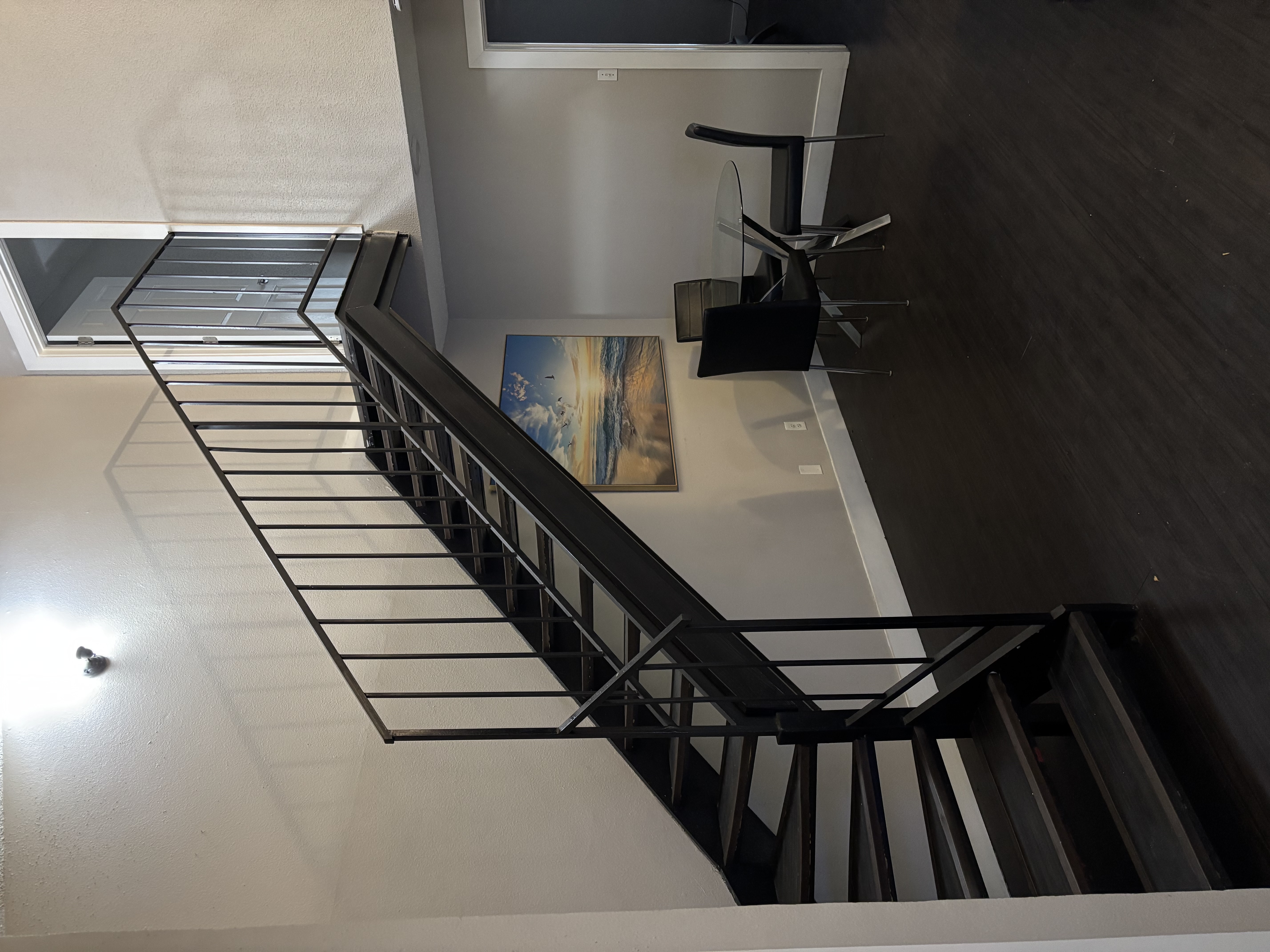 Affordable two-bedroom men’s sober living apartment in Austin with staircase and dining area under natural lighting