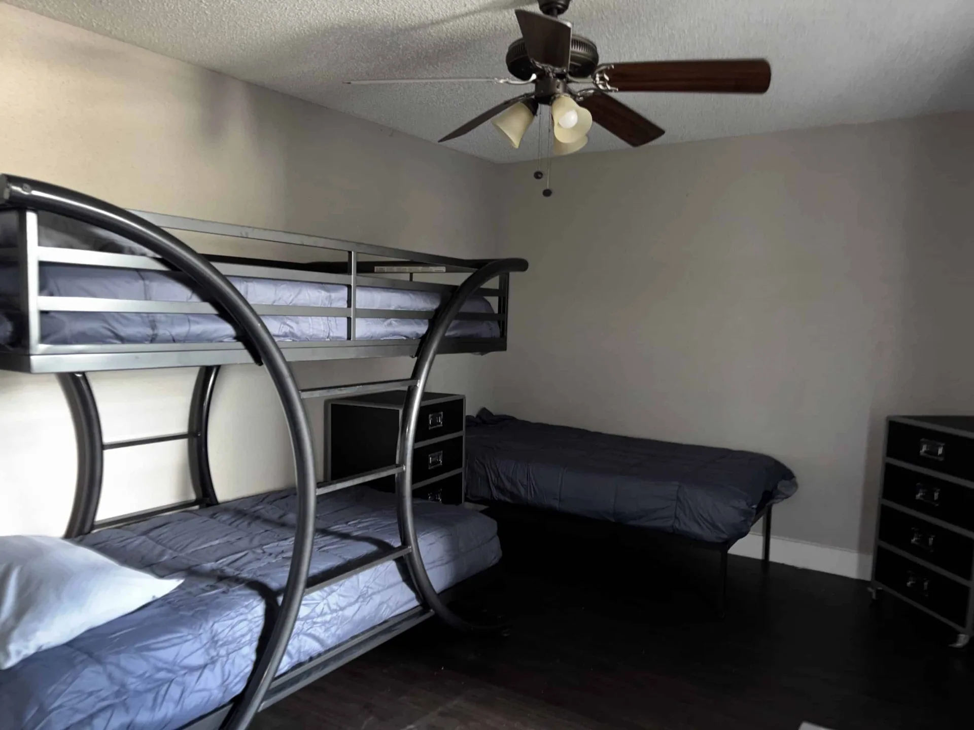 Shared living area in men’s sober housing Austin with brown sofa and glass tables