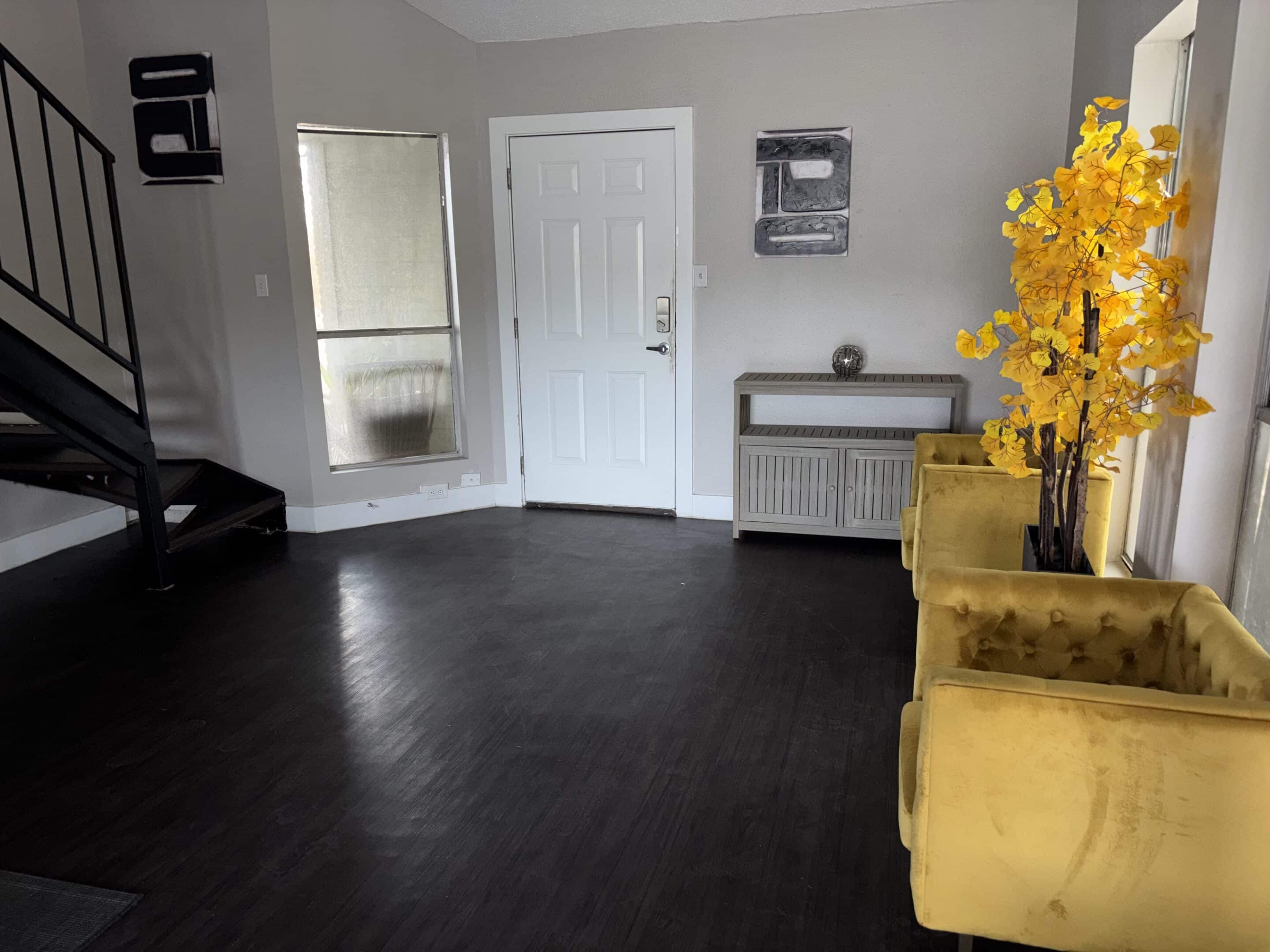 Austin men’s sober apartment living room with TV, couch, and dining area