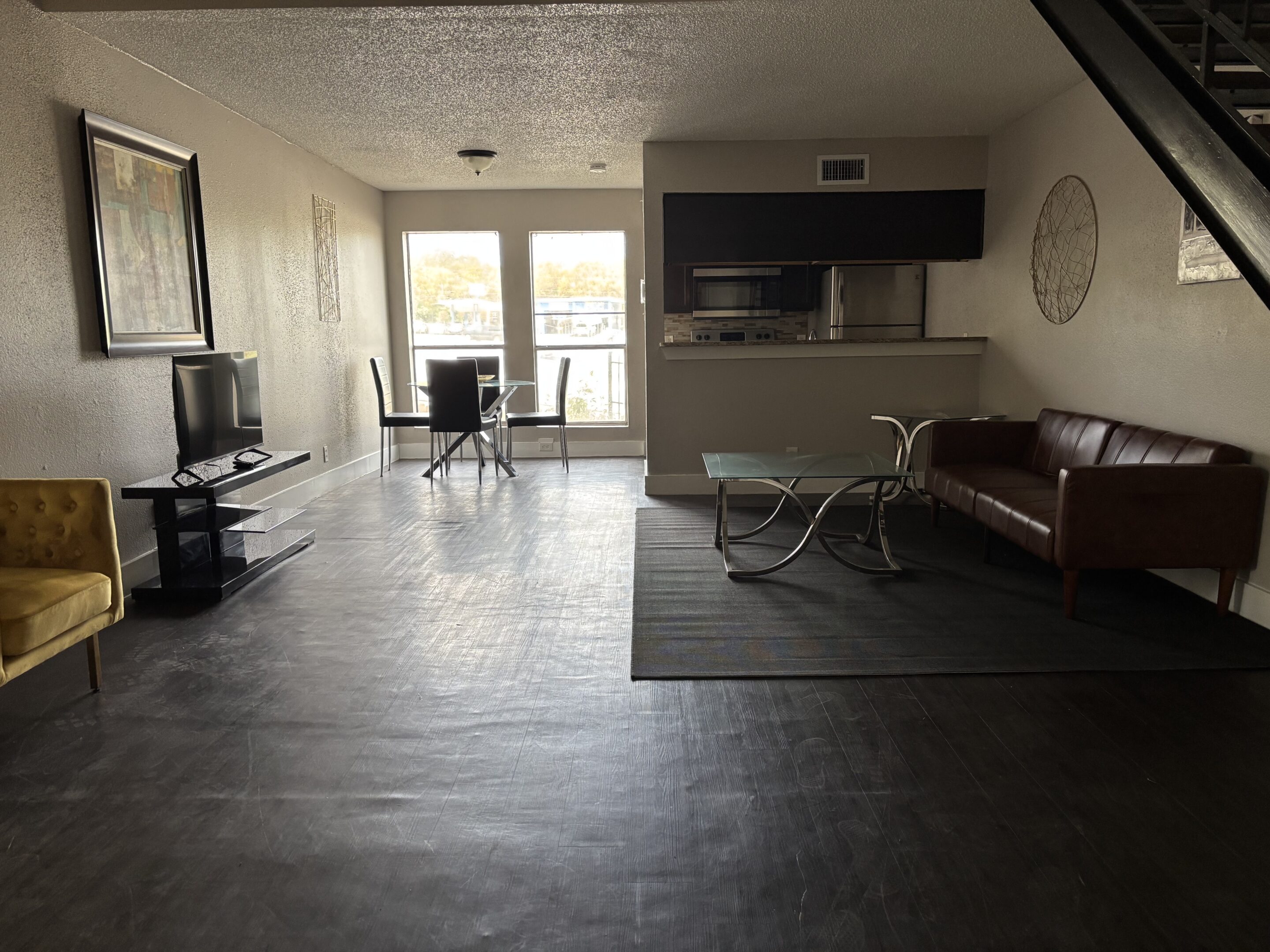 Entry area in Austin men’s sober living home with yellow chairs and natural light