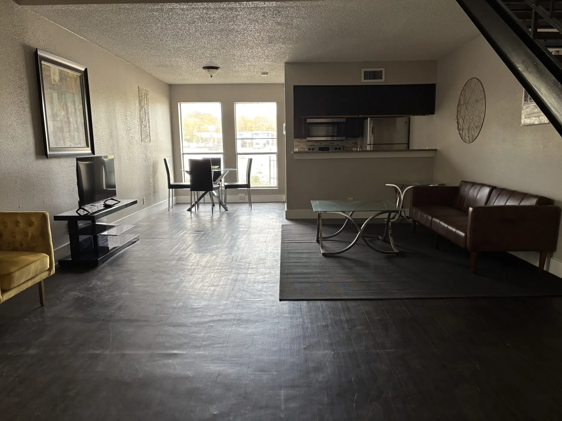 Entry area in Austin men’s sober living home with yellow chairs and natural light