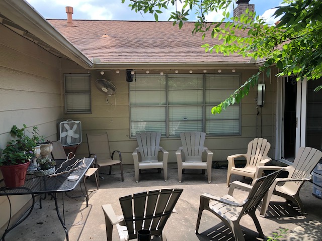 Outdoor patio area with chairs and table at Eudaimonia’s Parkfield Drive women’s sober living home in Austin.