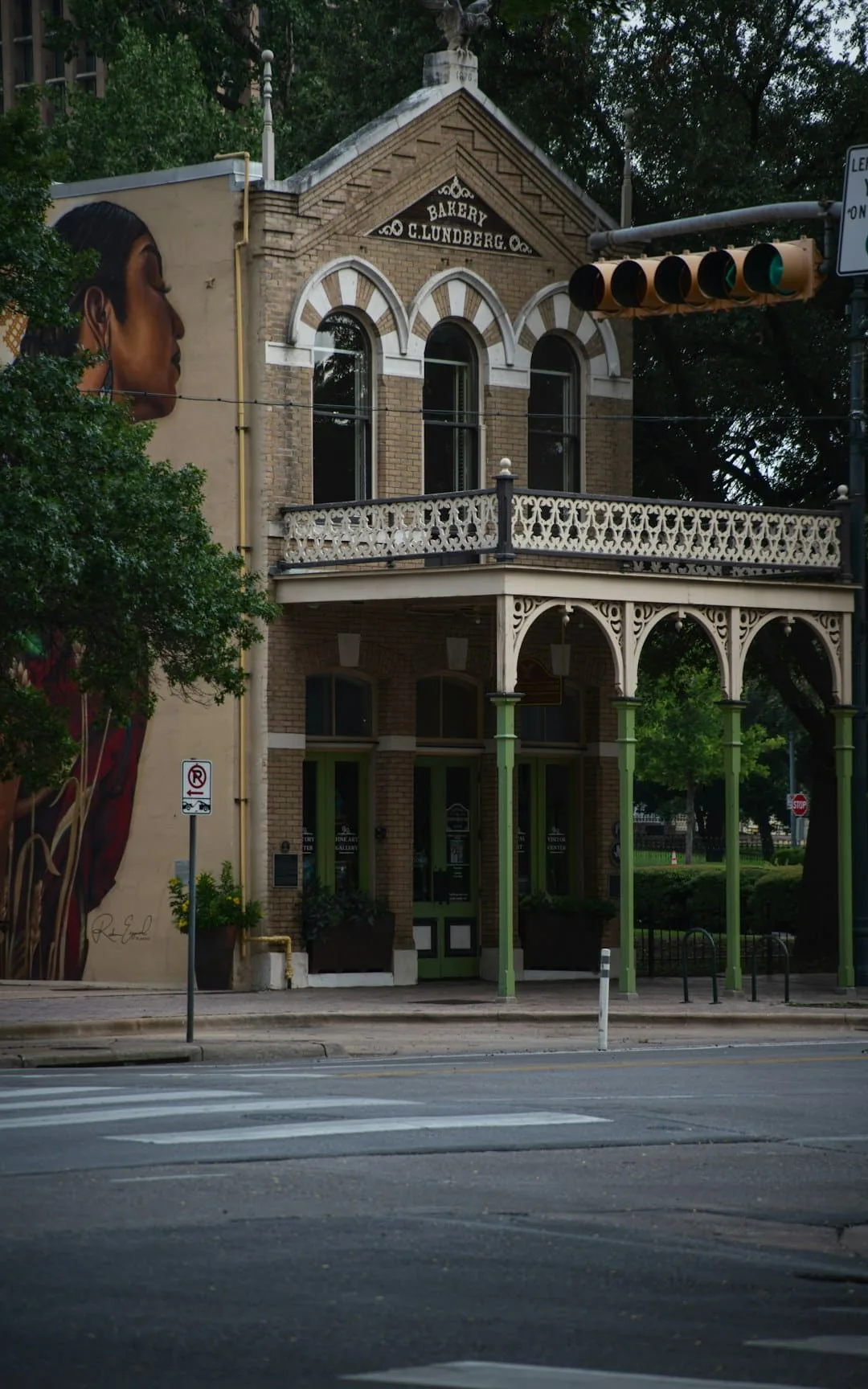 Building with mural and balcony on street corner -- Photo by Muyenda Burnett on Unsplash