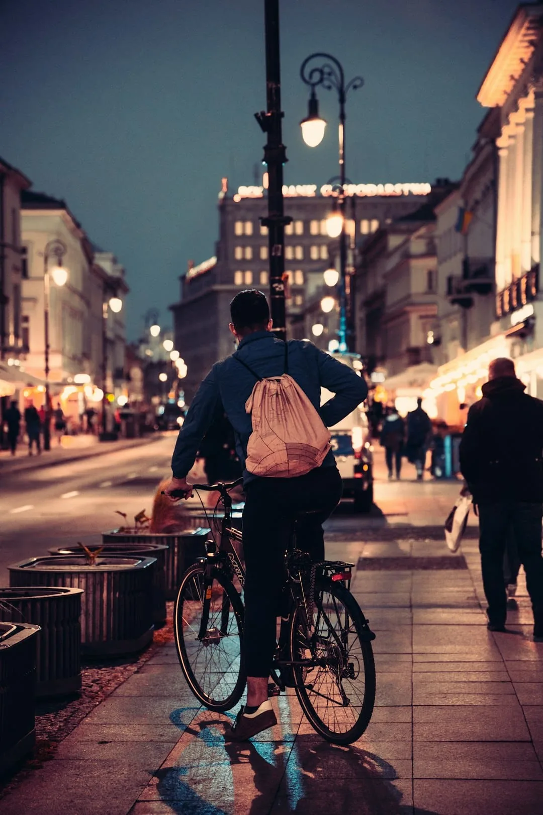 a person riding a bicycle on a city street -- Photo by Ammy Singh on Unsplash