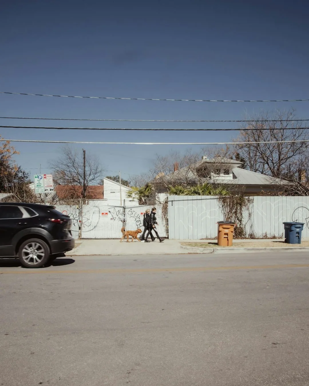 a black car parked on the side of a road -- Photo by Tasha Jolley on Unsplash