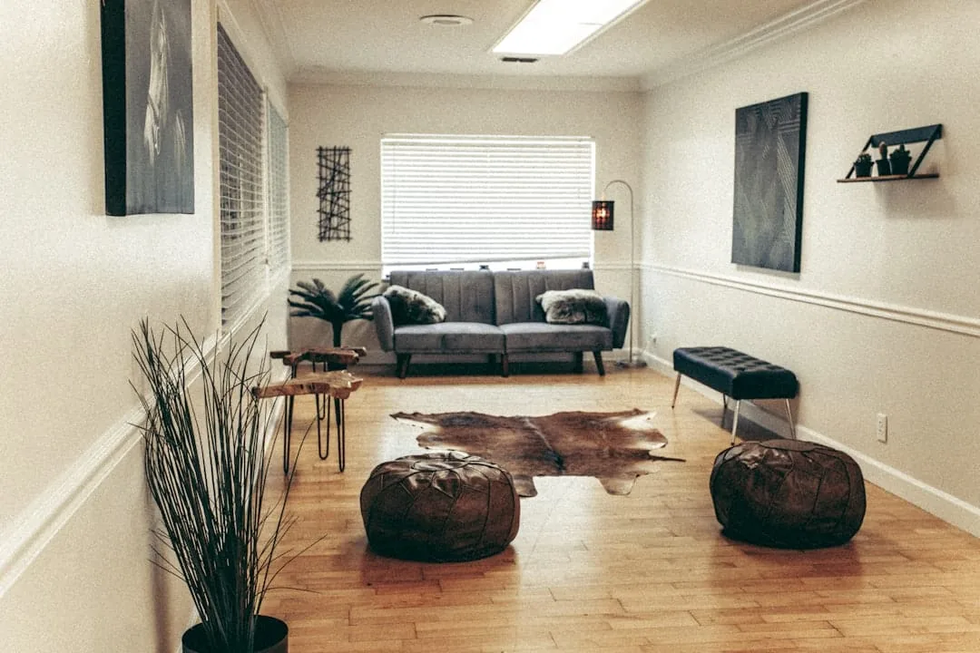 black leather sofa near brown wooden coffee table -- Photo by Cherosi on Unsplash