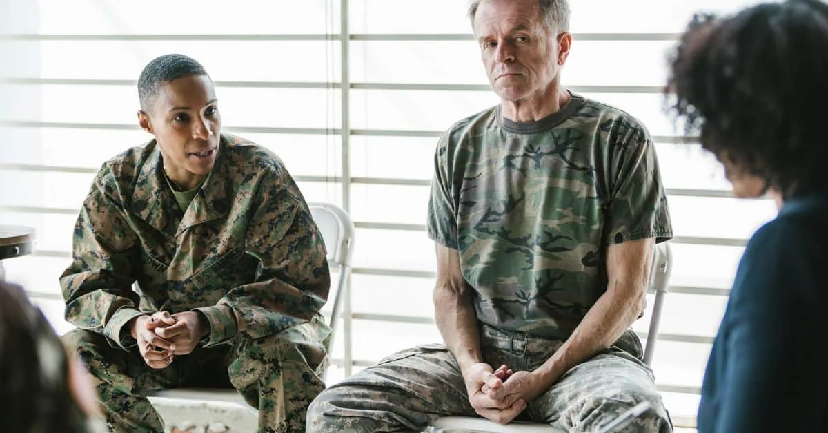 Military personnel discuss mental health in a supportive group therapy session.