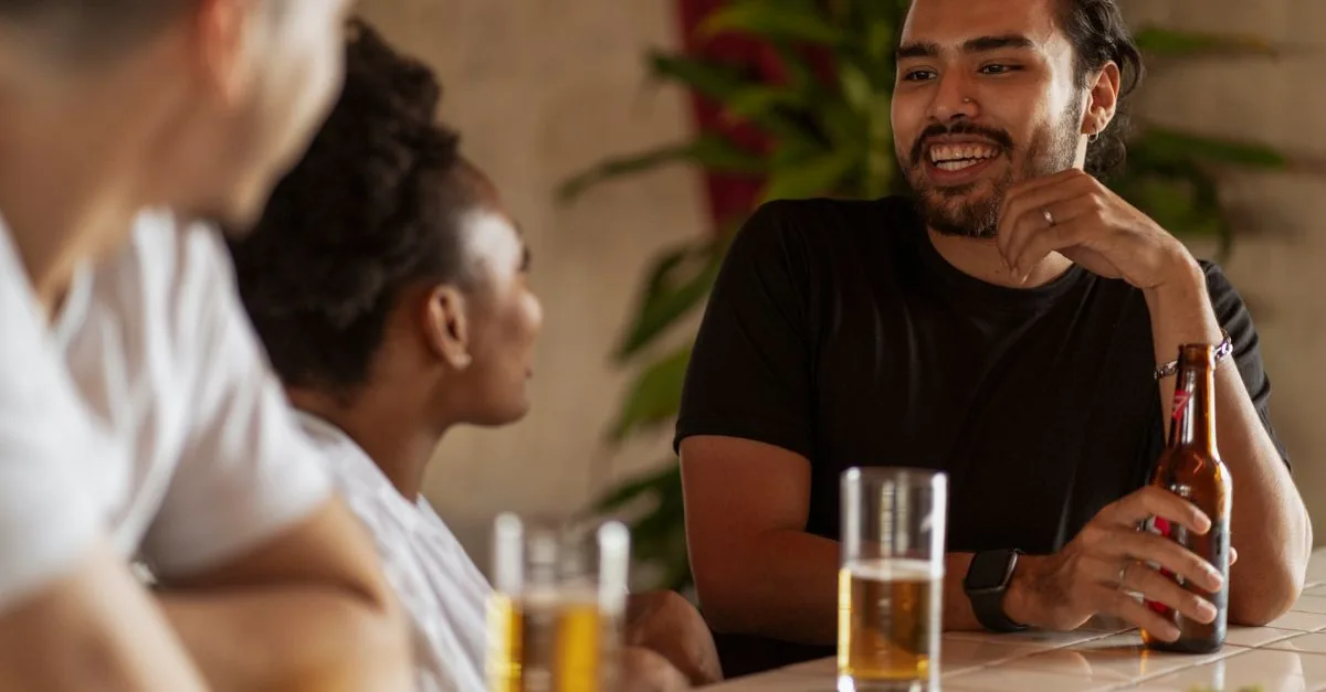 Group of friends socializing at a bar, sharing drinks and good times.