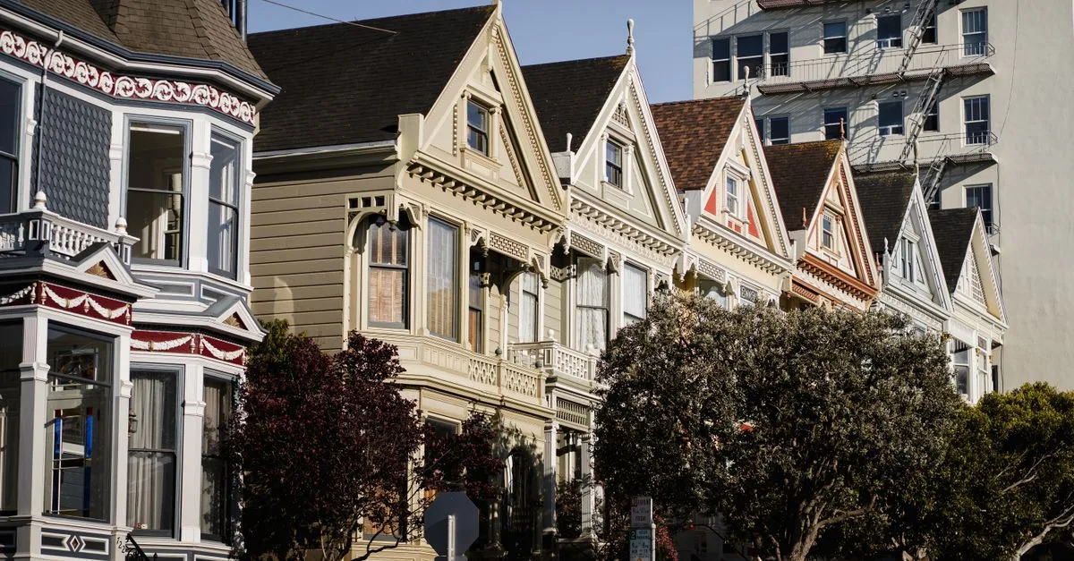 Charming Painted Ladies houses under clear skies in San Francisco, California.