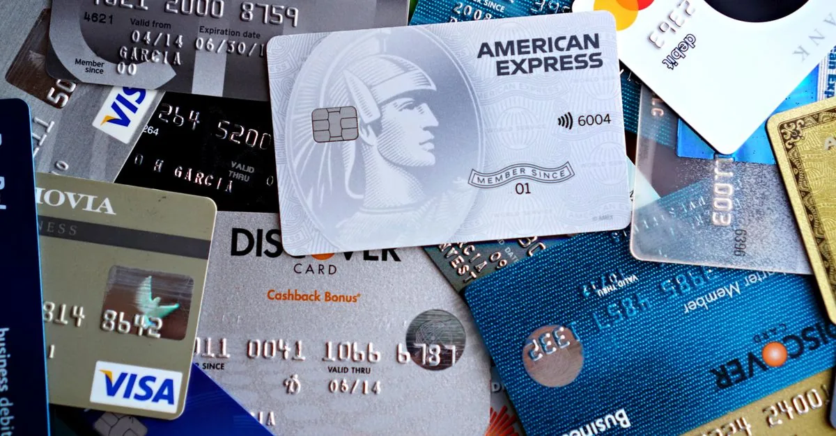 Close-up image of various credit and debit cards including Visa, MasterCard, American Express, and Discover.