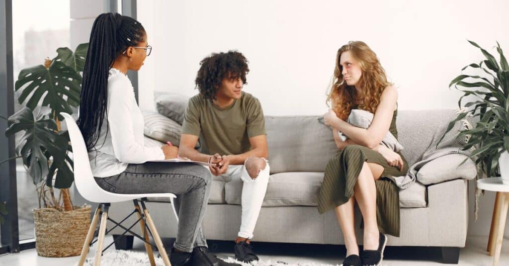 A diverse group engaged in a therapy session in a stylish, modern living room.