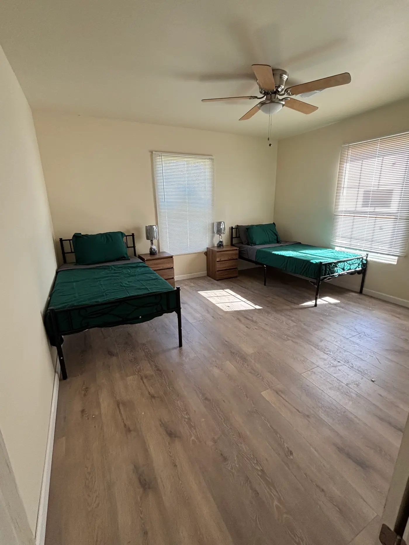 Bedroom with two single beds either side of a window.