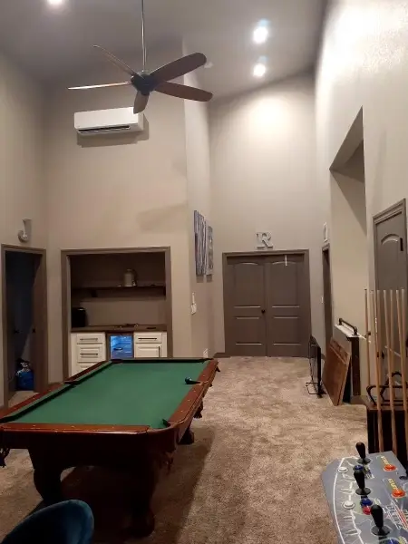 Games room with a pool table beneath a ceiling fan.