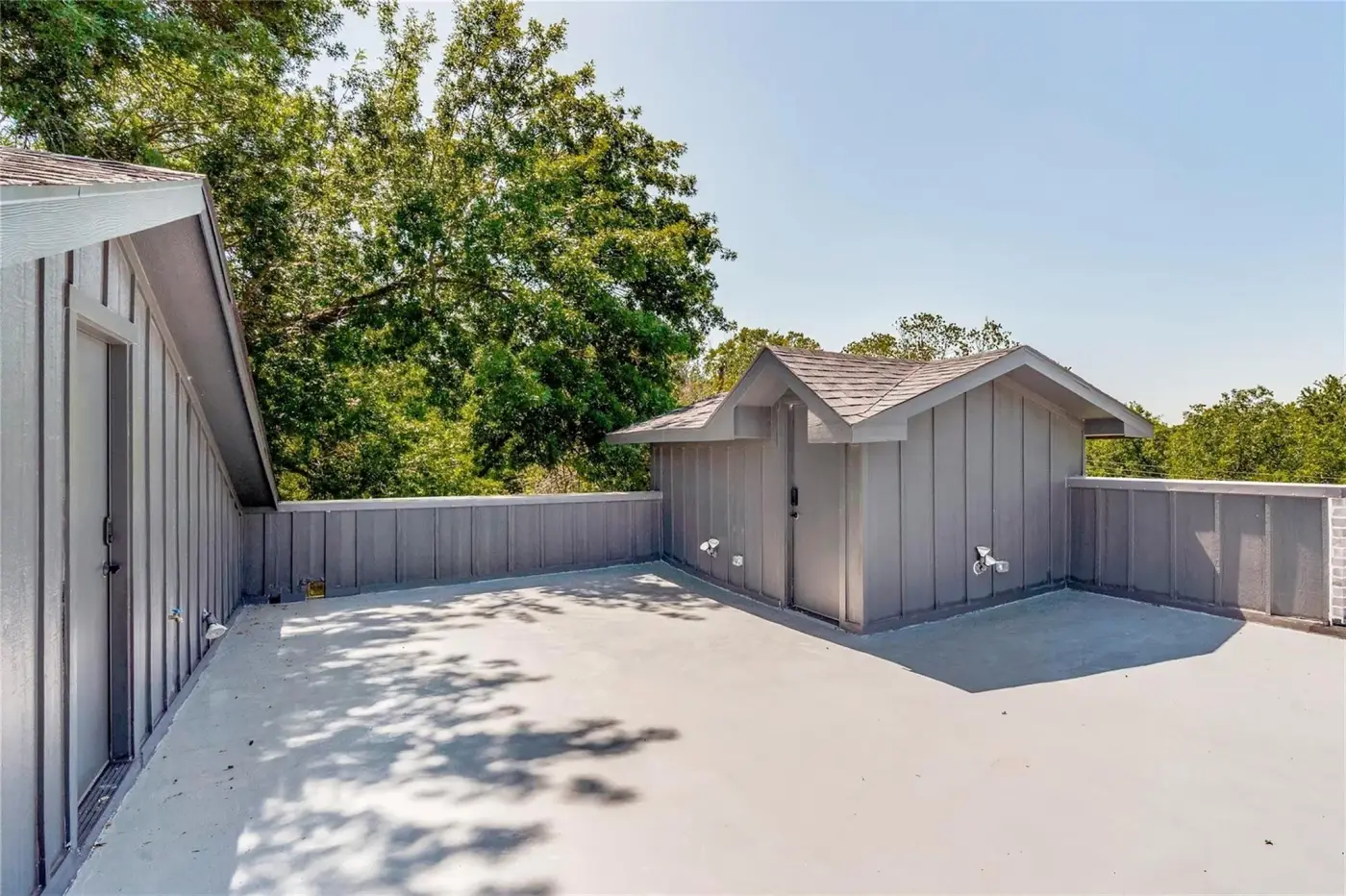 Back yard with a concrete patio and a storage shed.