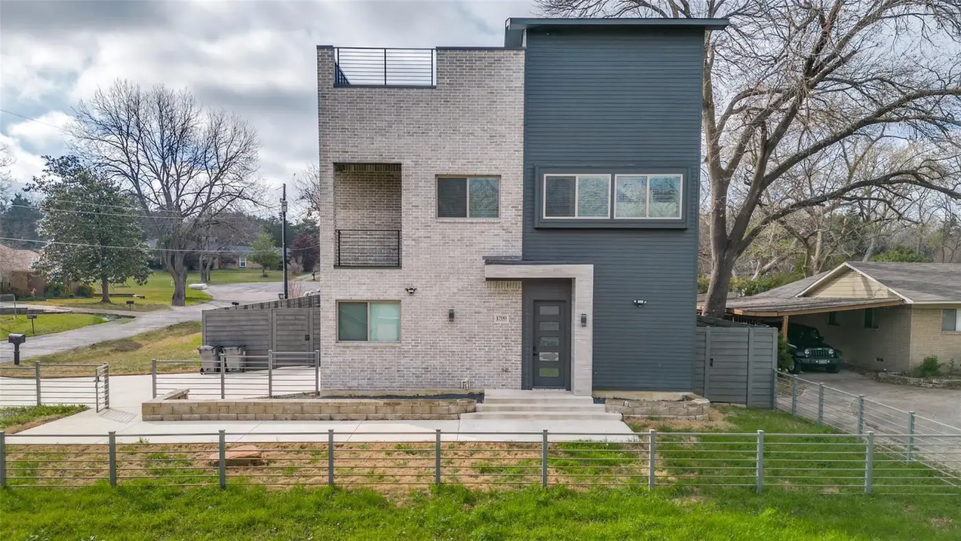 Front of the modern two-story house from the lawn.
