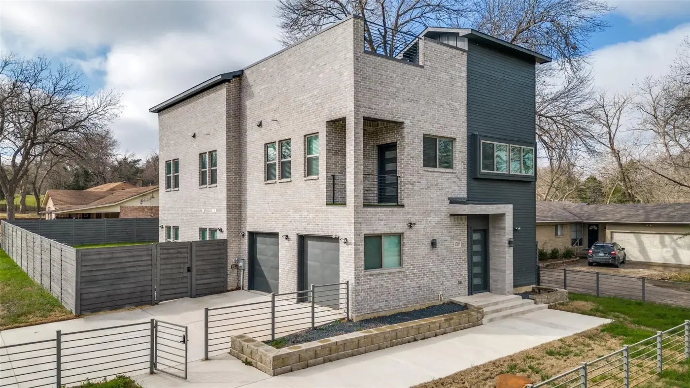 Front of the modern two-story house from the side.