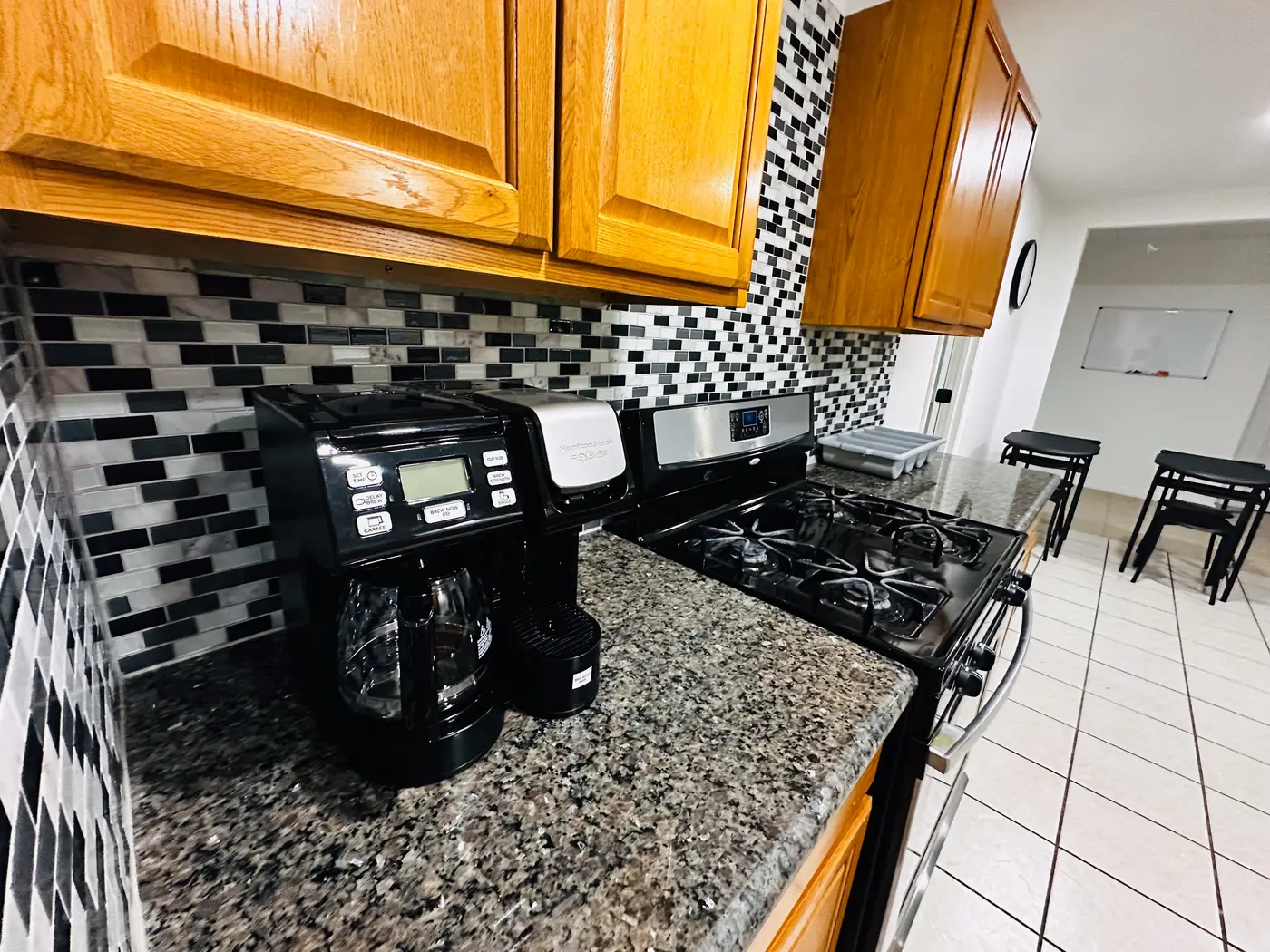Kitchen with granite counters and a mosaic tile backsplash.