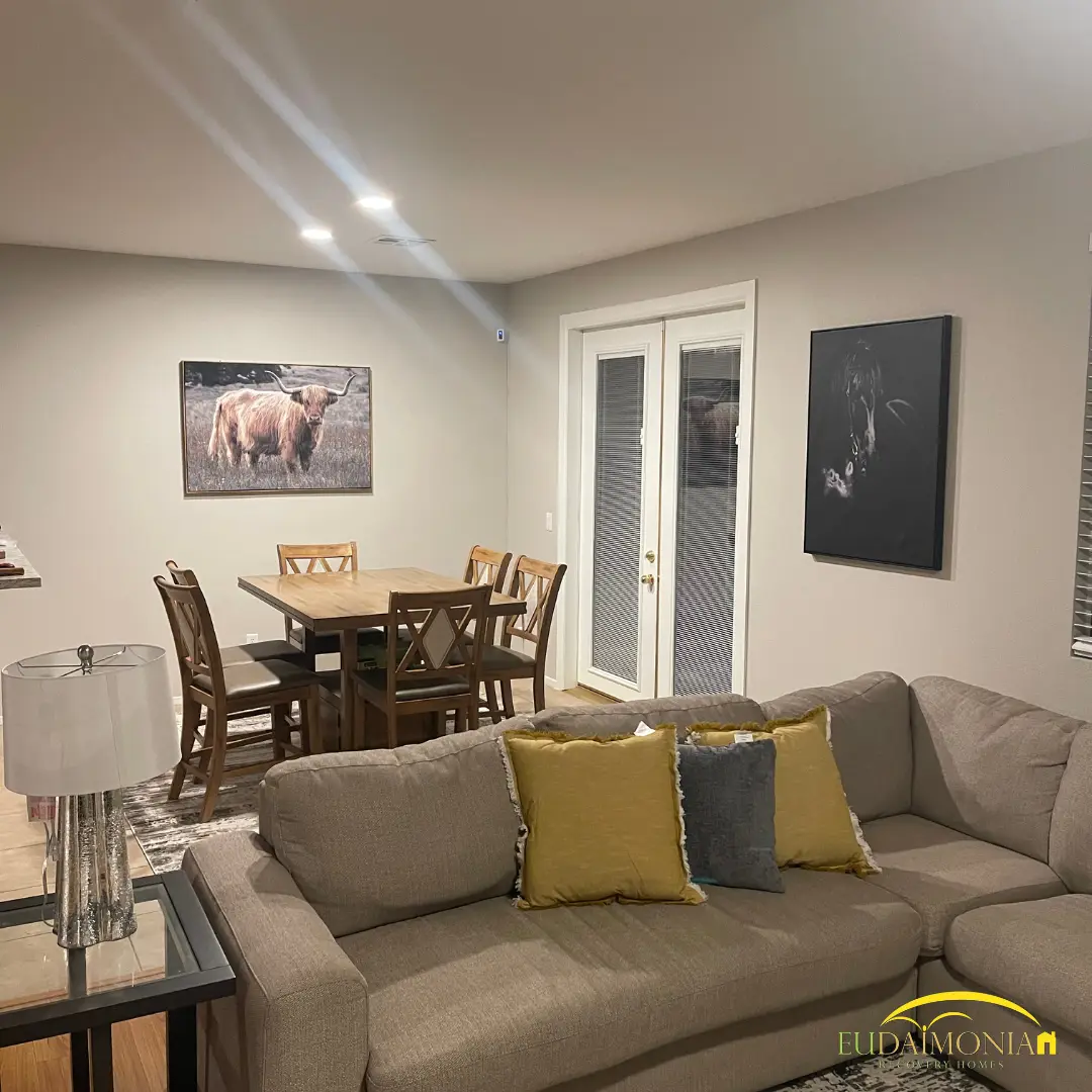 Dining table and a sectional in an open-plan living room.