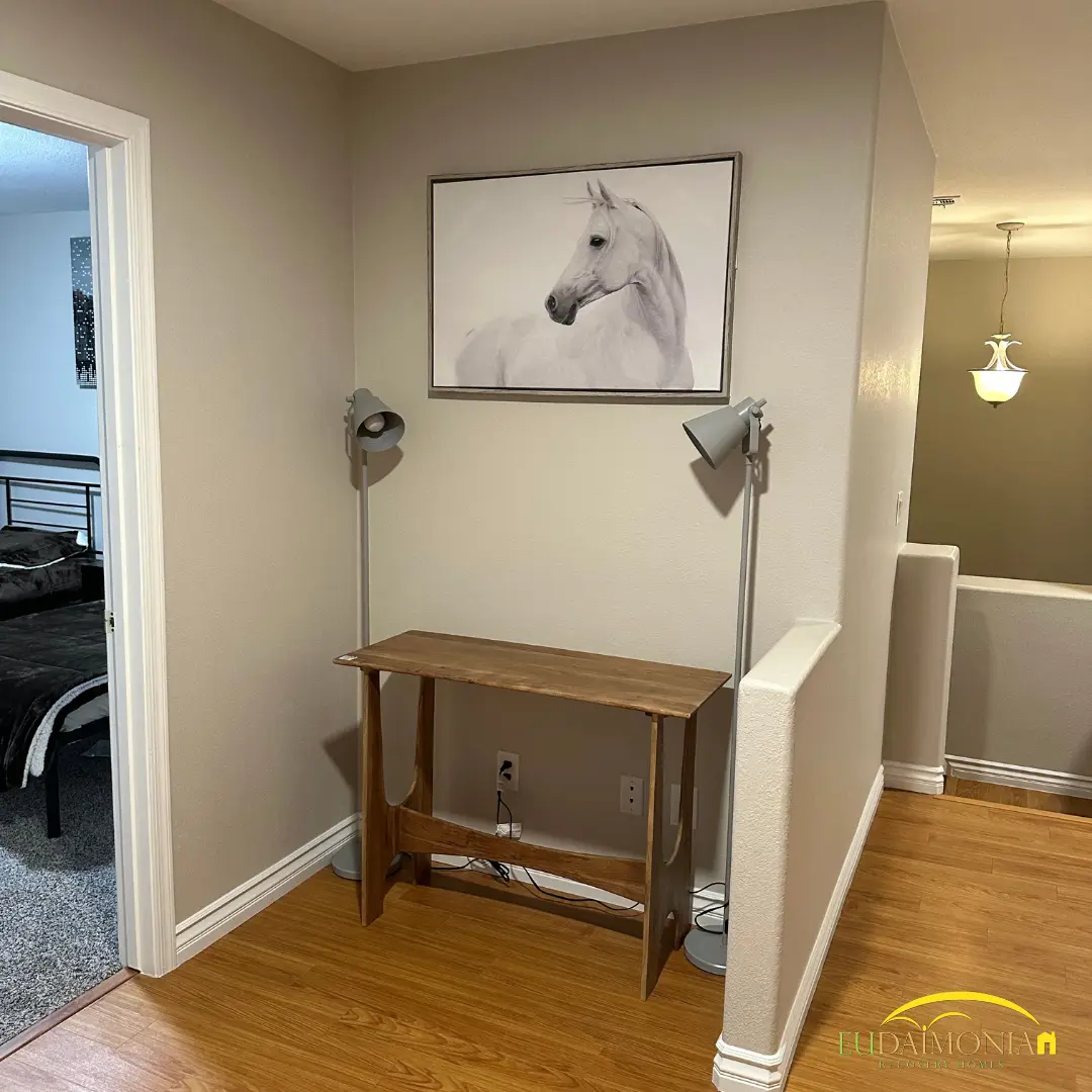Landing with a console table beneath a framed horse print.