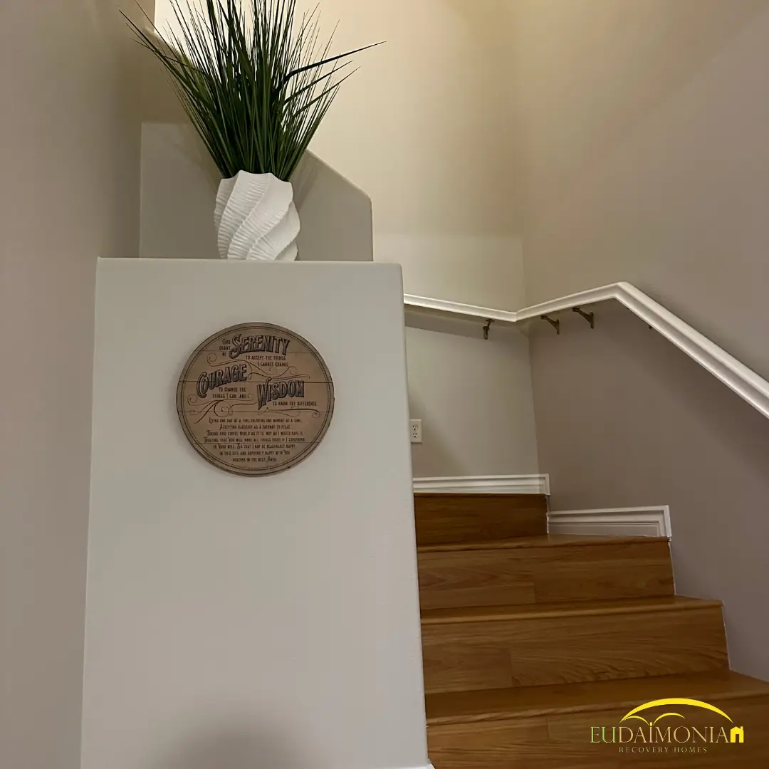 Staircase with a wall plaque on the half-landing.