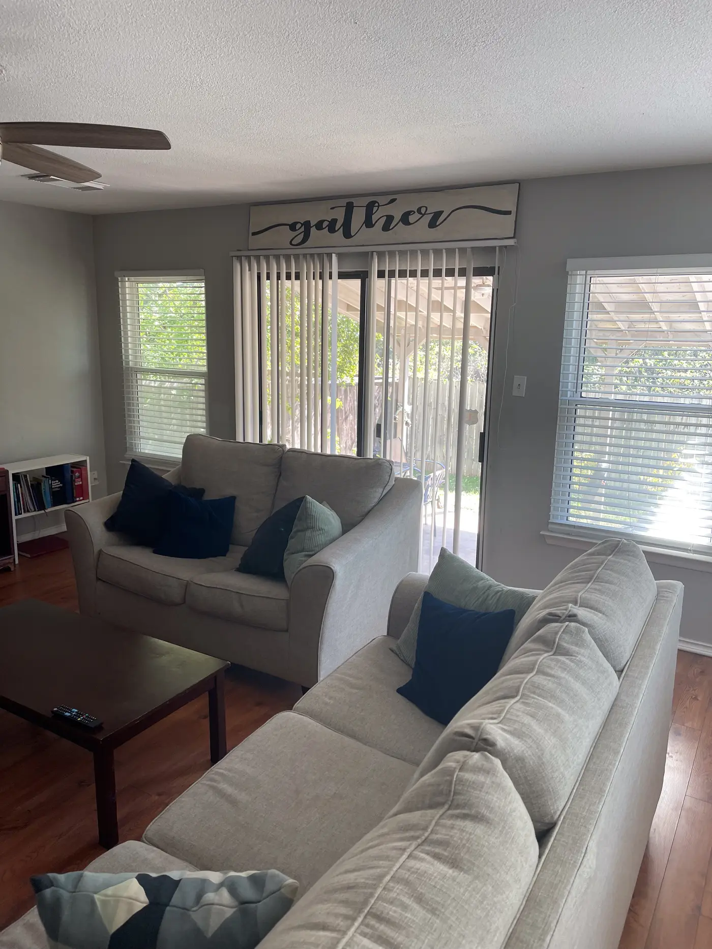 Living room with a large sectional and sliding doors to the garden.