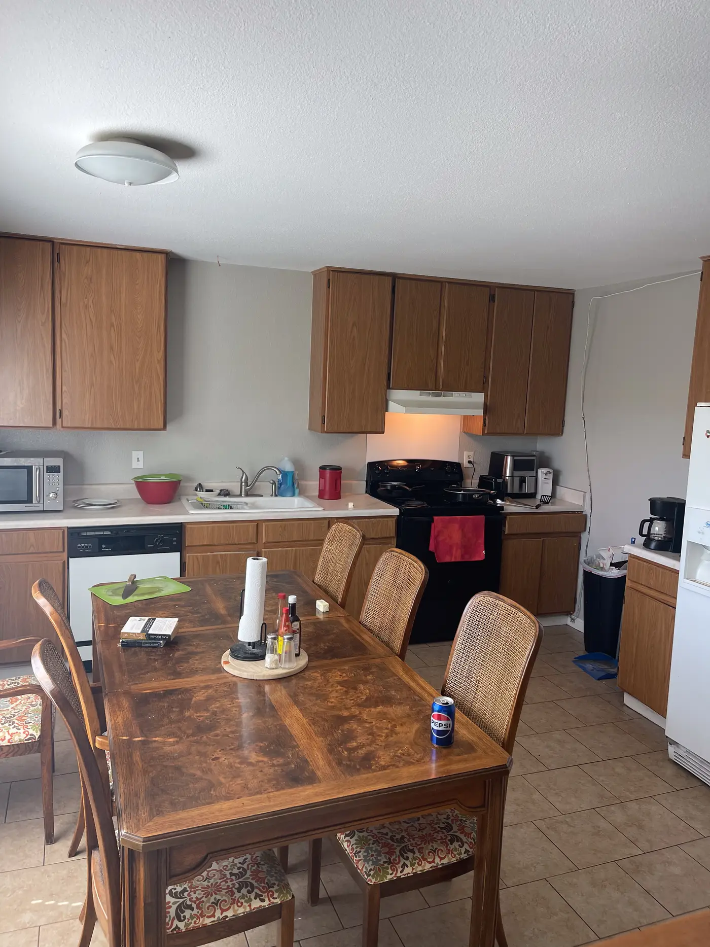 Kitchen and dining area with a wooden table and chairs.