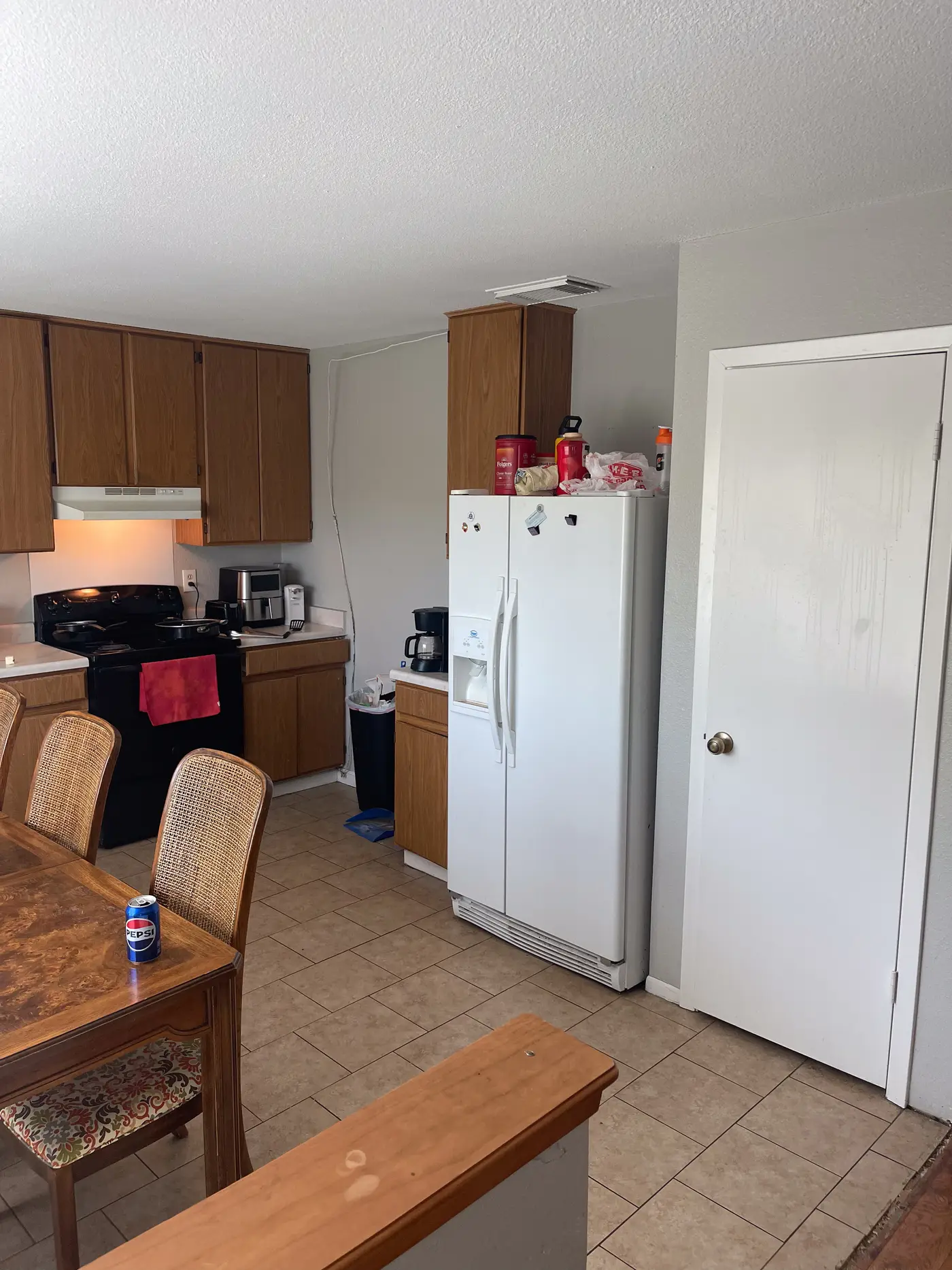 Kitchen with wood cabinets and a white refrigerator.