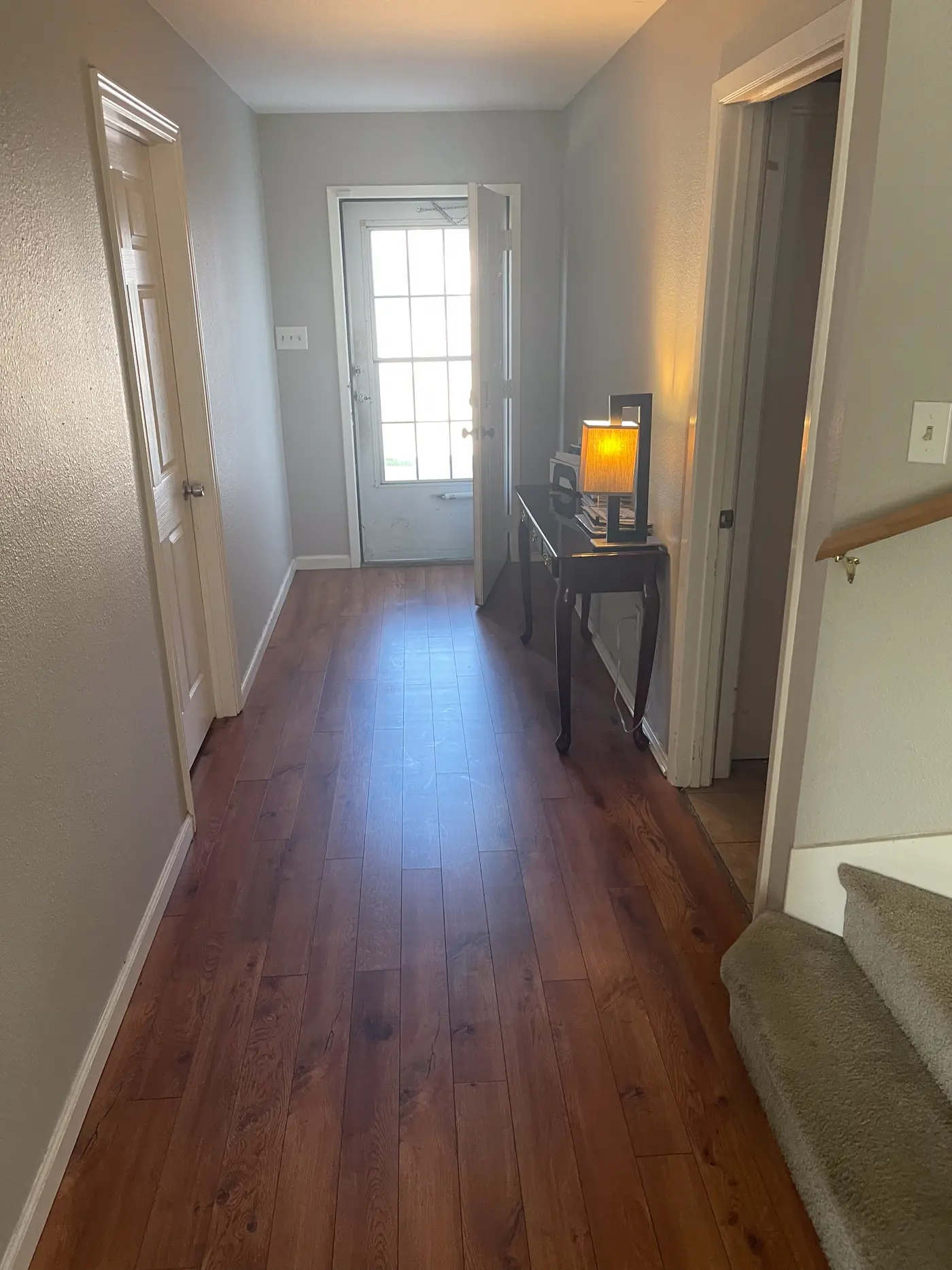 Entrance hallway on wood flooring looking toward the front door.