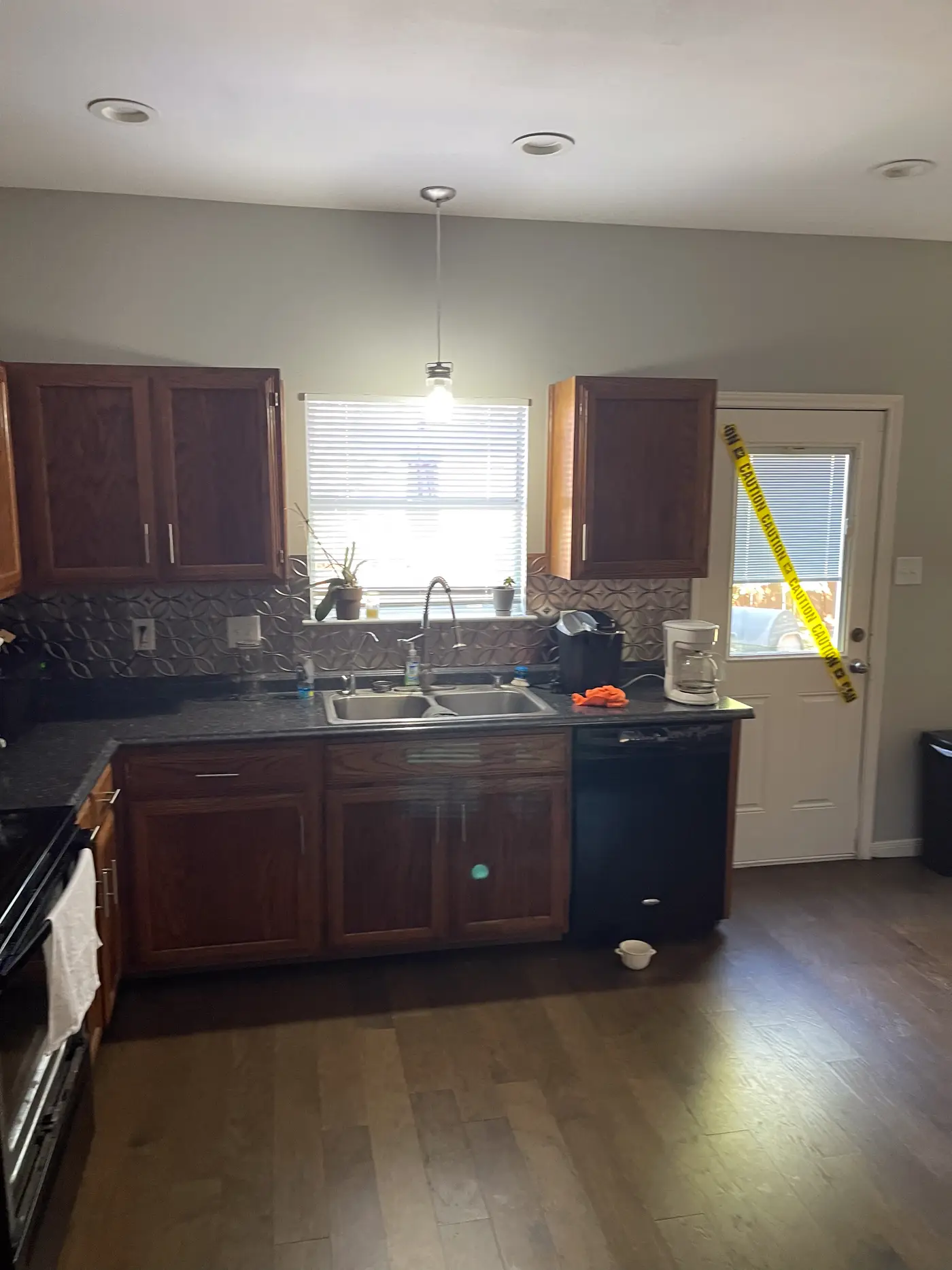 Kitchen with a central island and a door through to the garden.