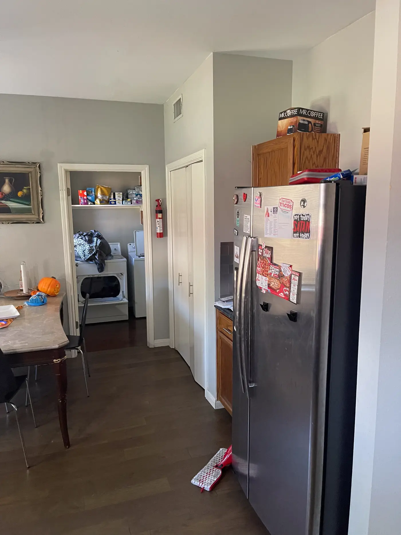 Kitchen with a stainless refrigerator beside the dining area.