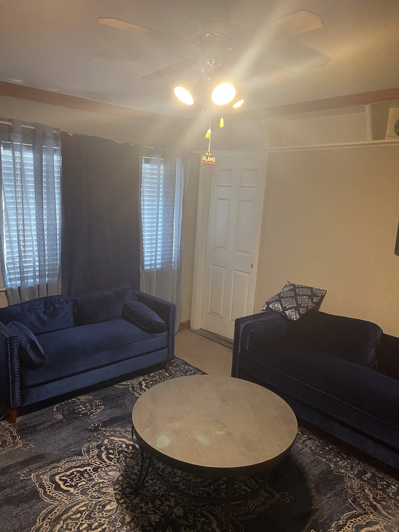 Living room with a navy sofa beneath framed art.