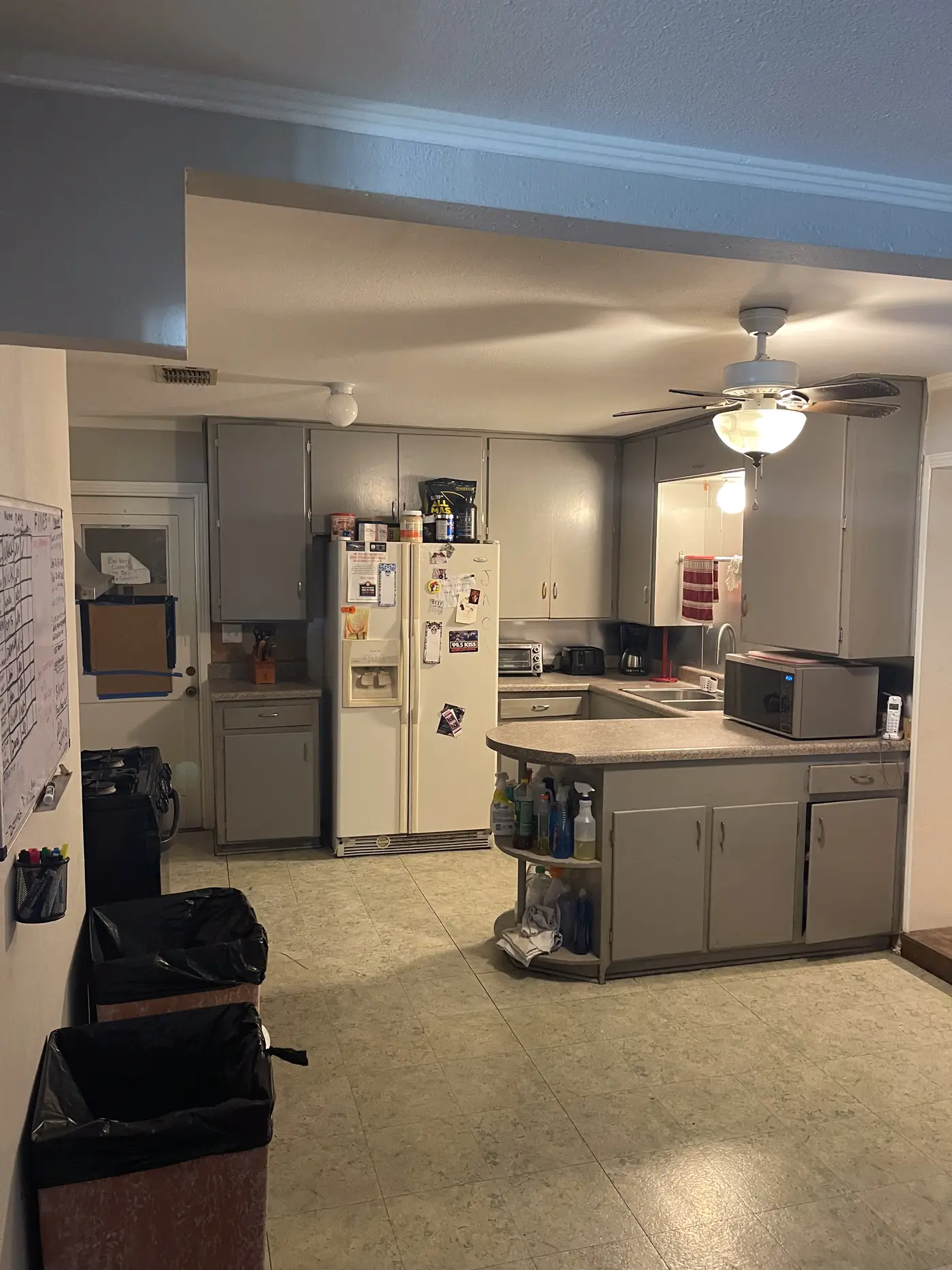 Kitchen with a stainless refrigerator and fitted cabinets.
