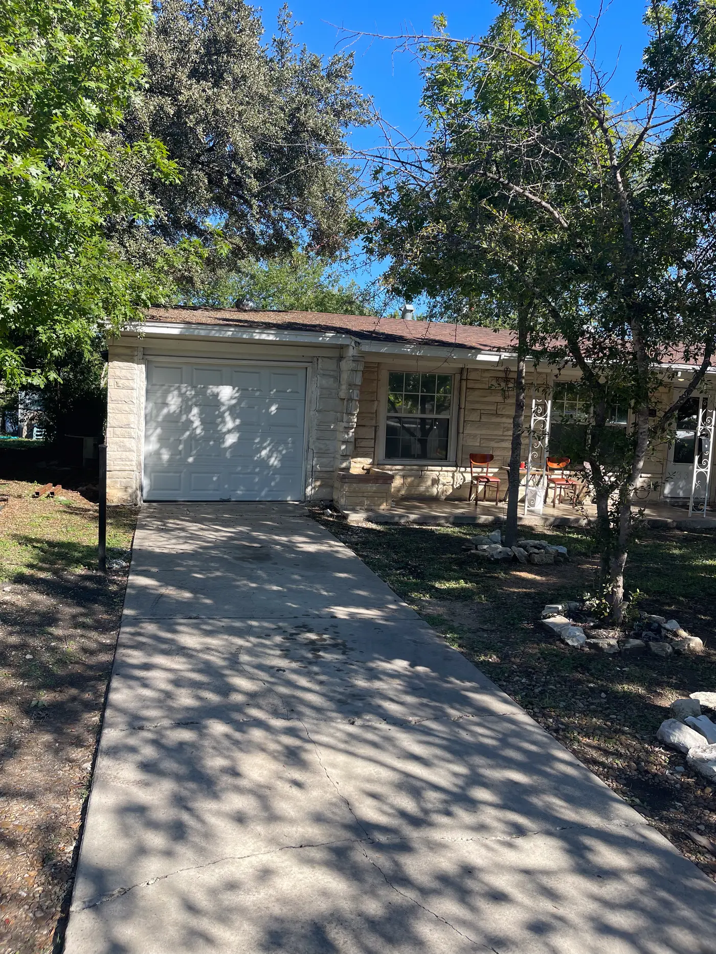 Front of the house with the driveway and garage.