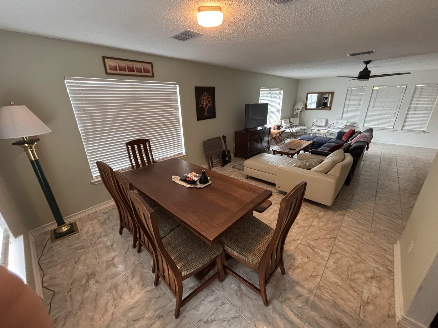 Living room seen from the foot of the staircase, with the dining table beyond.
