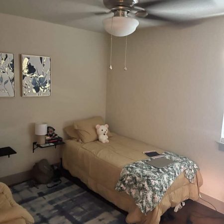 Cozy single bedroom at Quail Meadow women’s sober living Austin TX with neutral décor and supportive environment.