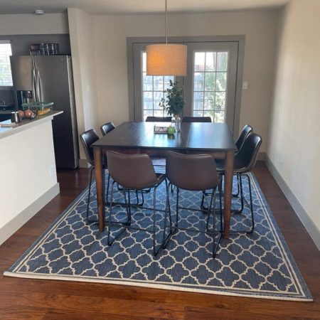 Dining area at Quail Meadow women’s sober living Austin TX with large table and modern kitchen.