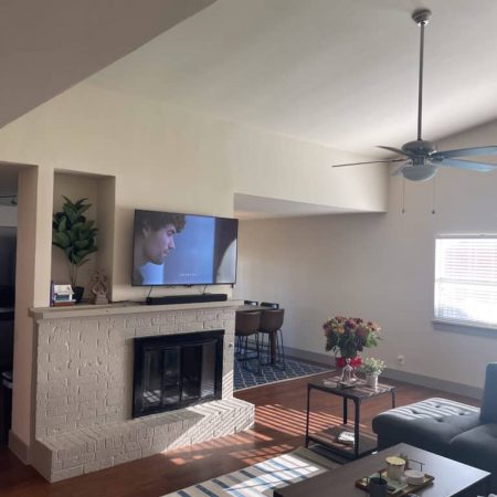 Bright living room at Quail Meadow women’s sober living Austin TX featuring fireplace, TV, and comfortable seating.
